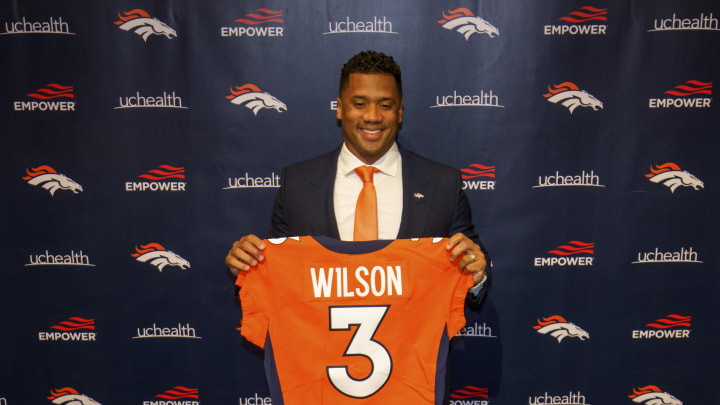 ENGLEWOOD, CO – MARCH 16: Quarterback Russell Wilson #3 of the Denver Broncos poses with his jersey after speaking to the media at UCHealth Training Center on March 16, 2022 in Englewood, Colorado. (Photo by Justin Edmonds/Getty Images)