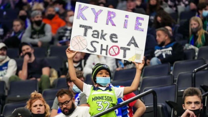 Jan 23, 2022; Minneapolis, Minnesota, USA; A young fan holds up a sign for Brooklyn Nets guard Kyrie Irving (11) prior to the game against the Minnesota Timberwolves at Target Center. Mandatory Credit: Brace Hemmelgarn-USA TODAY Sports