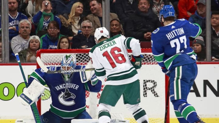 VANCOUVER, BC - DECEMBER 4: Ben Hutton #27 and Anders Nilsson #31 of the Vancouver Canucks look on as Jason Zucker #16 of the Minnesota Wild scores his first goal during their NHL game at Rogers Arena December 4, 2018 in Vancouver, British Columbia, Canada. (Photo by Jeff Vinnick/NHLI via Getty Images)