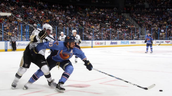 ATLANTA - APRIL 10: Dustin Byfuglien #33 of the Atlanta Thrashers battles for the puck against Matt Niskanen #2 of the Pittsburgh Penguins at Philips Arena on April 10, 2011 in Atlanta, Georgia. (Photo by Scott Cunningham/NHLI via Getty Images)