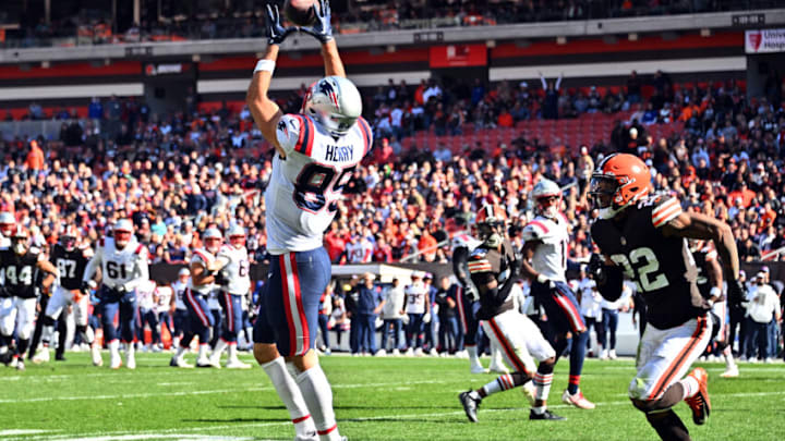 CLEVELAND, OHIO - OCTOBER 16: Hunter Henry #85 of the New England Patriots catches a pass while Grant Delpit #22 of the Cleveland Browns defends during the first half at FirstEnergy Stadium on October 16, 2022 in Cleveland, Ohio. (Photo by Jason Miller/Getty Images)