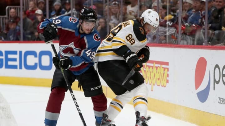 DENVER, COLORADO - OCTOBER 10: Samuel Girard #49 of the Colorado Avalanche and David Pastrnak #88 of the Boston Bruins fight for the puck in the first period at the Pepsi Center on October 10, 2019 in Denver, Colorado. (Photo by Matthew Stockman/Getty Images)