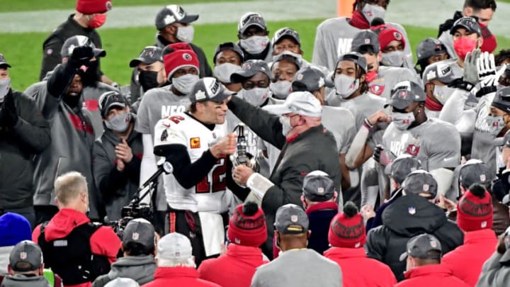 Jan 24, 2021; Green Bay, Wisconsin, USA; Tampa Bay Buccaneers quarterback Tom Brady (12) and head coach Bruce Arians celebrate with the George Halas Trophy after beating the Green Bay Packers in the NFC Championship Game at Lambeau Field . Mandatory Credit: Benny Sieu-USA TODAY Sports