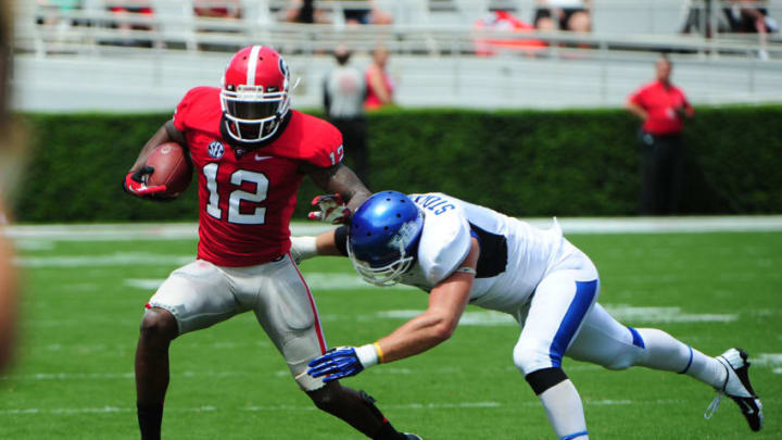 ATHENS, GA - SEPTEMBER 1: Tavarres King #12 of the Georgia Bulldogs runs with a catch against Jake Stockman #9 of the Buffalo Bulls at Sanford Stadium on September 1, 2012 in Athens, Georgia. (Photo by Scott Cunningham/Getty Images)