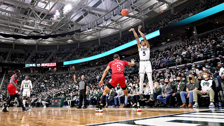 Jan 5, 2022; East Lansing, Michigan, USA; Michigan State Spartans guard Max Christie (5) shoots over Nebraska Cornhuskers guard Bryce McGowens (5) in the second half at Jack Breslin Student Events Center. Mandatory Credit: Dale Young-USA TODAY Sports