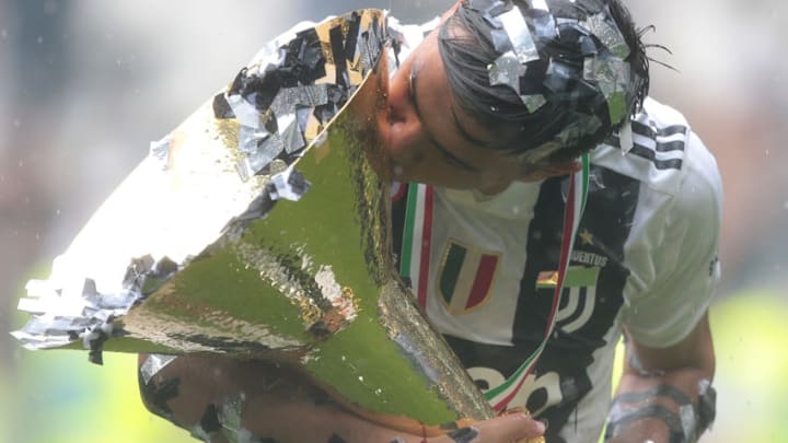 TURIN, ITALY - MAY 19: Paulo Dybala of Juventus FC celebrates with the trophy after winning the Serie A Championship at the end of the serie A match between Juventus and Hellas Verona FC at Allianz Stadium on May 19, 2018 in Turin, Italy. (Photo by Emilio Andreoli/Getty Images)