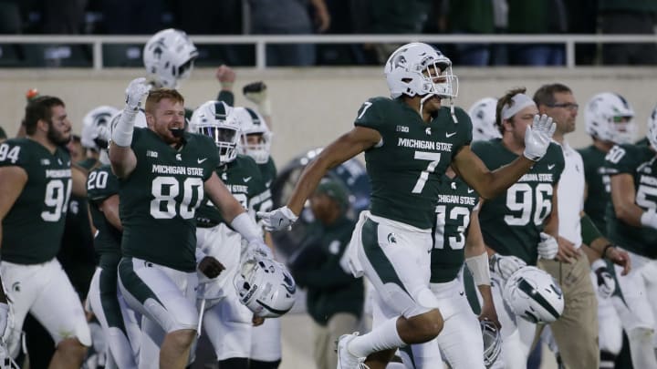 EAST LANSING, MI – SEPTEMBER 30: Tight end Matt Seybert #80 of the Michigan State Spartans and wide receiver Cody White #7 of the Michigan State Spartans celebrates a 17-7 win over the Iowa Hawkeyes at Spartan Stadium on September 30, 2017 in East Lansing, Michigan. (Photo by Duane Burleson/Getty Images)