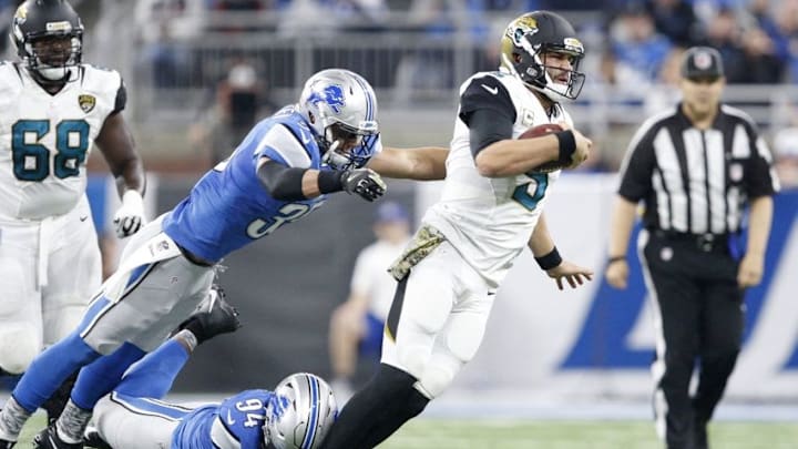 Nov 20, 2016; Detroit, MI, USA; Jacksonville Jaguars quarterback Blake Bortles (5) tackled by Detroit Lions defensive end Ezekiel Ansah (94) and strong safety Miles Killebrew (35) during the first quarter at Ford Field. Mandatory Credit: Raj Mehta-USA TODAY Sports