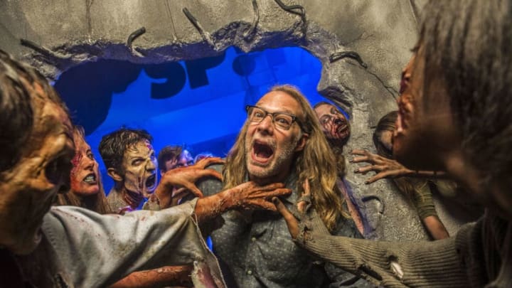 ORLANDO, FL - OCTOBER 25: In this handout photo provided by Universal Orlando, Greg Nicotero, Co-Executive Producer and Director of Special Effects Make-Up Artist for AMC's 'The Walking Dead,' found himself surrounded by a horde of walkers at Universal Orlando's Halloween Horror Nights 24 on October 25, 2014 in Orlando, Florida. During his visit to the event on October 25, Nicotero experienced the real-life terror of his own undead creations inside AMC's The Walking Dead: End of the Line haunted house. The Walking Dead: End of the Line is the biggest house in Halloween Horror Nights history featuring the largest cast of scareactors. It is one of this year's most popular haunted houses, surpassing guest ratings from both 2013's and 2012's incredibly popular experiences based on the hit television show. Universal's Halloween Horror Nights 24 runs on select nights now through November 1. For more information, visit: HalloweenHorrorNights.com/Orlando. (Photo by Roberto Gonzales/Universal Orlando via Getty Images)