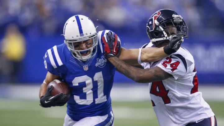 INDIANAPOLIS, IN - DECEMBER 15: Donald Brown #31 of the Indianapolis Colts runs the brown and give a stiff arm to Johnathan Joseph #24 of the Houston Texans at Lucas Oil Stadium on December 15, 2013 in Indianapolis, Indiana. (Photo by Michael Hickey/Getty Images)