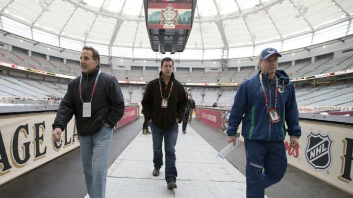 VANCOUVER, BC - MARCH 1: Head coach John Tortorella and assistant coaches Mike Sullivan and Glen Gulutzan (l to r) of the Vancouver Canucks check the facilities before practice Saturday for the 2014 Tim Hortons NHL Heritage Classic against the Ottawa Senators at BC Place Stadium March 1, 2014 in Vancouver, British Columbia, Canada. (Photo by Jeff Vinnick/NHLI via Getty Images)