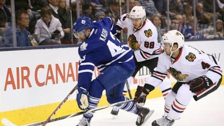 Jan 15, 2016; Toronto, Ontario, CAN; Toronto Maple Leafs center Nazem Kadri (43) carries the puck as he is pressured by Chicago Blackhawks defenseman Niklas Hjalmarsson (4) at Air Canada Centre. Mandatory Credit: Tom Szczerbowski-USA TODAY Sports