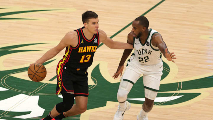 MILWAUKEE, WISCONSIN - JUNE 25: Khris Middleton #22 of the Milwaukee Bucks defends against Bogdan Bogdanovic #13 of the Atlanta Hawks during the second half in game two of the Eastern Conference Finals at Fiserv Forum on June 25, 2021 in Milwaukee, Wisconsin. NOTE TO USER: User expressly acknowledges and agrees that, by downloading and or using this photograph, User is consenting to the terms and conditions of the Getty Images License Agreement. (Photo by Stacy Revere/Getty Images)