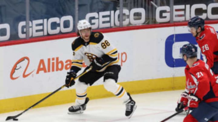 Feb 1, 2021; Washington, District of Columbia, USA; Boston Bruins right wing David Pastrnak (88) skates with the puck as Washington Capitals right wing Garnet Hathaway (21) defends in the third period at Capital One Arena. Mandatory Credit: Geoff Burke-USA TODAY Sports