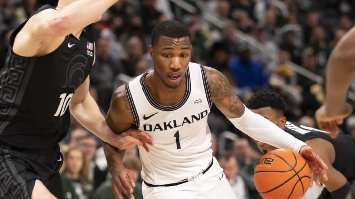 Dec 21, 2021; Detroit, Michigan, USA; Oakland Golden Grizzlies forward Jamal Cain (1) drives to the basket against Michigan State Spartans forward Joey Hauser (10) during the first half at Little Caesars Arena. Mandatory Credit: Raj Mehta-USA TODAY Sports