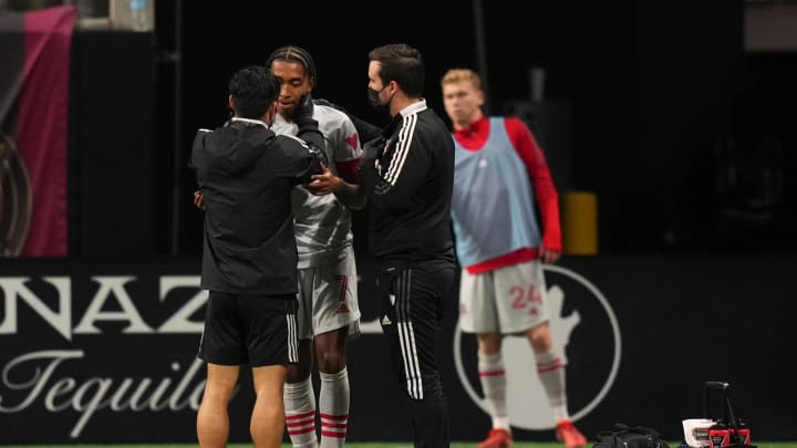 Oct 30, 2021; Atlanta, Georgia, USA; Toronto FC team trainers attend to forward Jayden Nelson (11) after an apparent injury during the second half against Atlanta United FC at Mercedes-Benz Stadium. Mandatory Credit: Jasen Vinlove-USA TODAY Sports