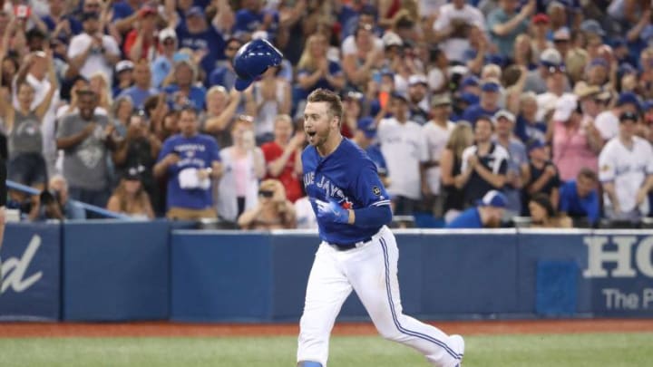 TORONTO, ON - JUNE 30: Justin Smoak #14 of the Toronto Blue Jays celebrates after hitting a game-winning solo home run in the ninth inning during MLB game action against the Detroit Tigers at Rogers Centre on June 30, 2018 in Toronto, Canada. (Photo by Tom Szczerbowski/Getty Images)