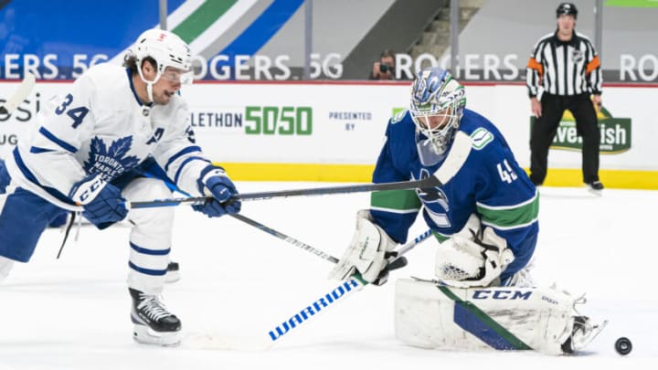 VANCOUVER, BC - APRIL 18: Auston Matthews #34 of the Toronto Maple Leafs is stopped by goalie Braden Holtby #49 of the Vancouver Canucks in close during the first period of NHL hockey action at Rogers Arena on April 17, 2021 in Vancouver, Canada. (Photo by Rich Lam/Getty Images)