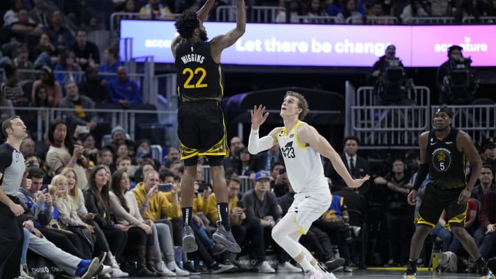 Andrew Wiggins of the Golden State Warriors shoots a three-point shot over Lauri Markkanen of the Utah Jazz during the fourth-quarter of a game at Chase Center on November 25, 2022. (Photo by Thearon W. Henderson/Getty Images)