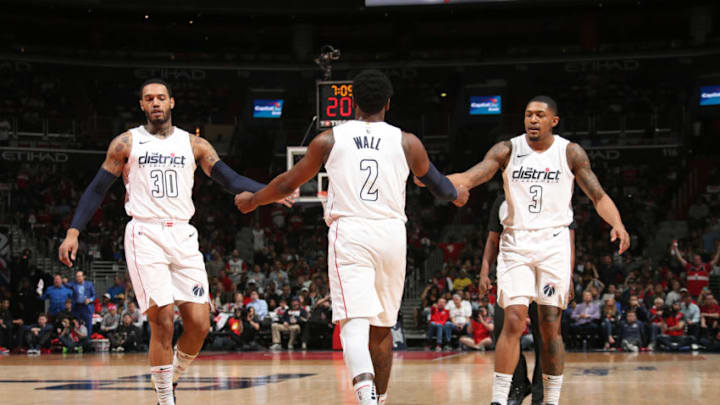 WASHINGTON, DC -  APRIL 22: Mike Scott #30, John Wall #2, and Bradley Beal #3 of the Washington Wizards react to a play against the Toronto Raptors in Game Four of Round One of the 2018 NBA Playoffs on April 22, 2018 at Capital One Arena in Washington, DC. NOTE TO USER: User expressly acknowledges and agrees that, by downloading and or using this Photograph, user is consenting to the terms and conditions of the Getty Images License Agreement. Mandatory Copyright Notice: Copyright 2018 NBAE (Photo by Ned Dishman/NBAE via Getty Images)