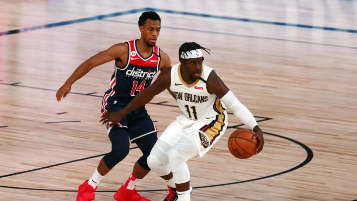 LAKE BUENA VISTA, FLORIDA – AUGUST 07: Jrue Holiday #11 of the New Orleans Pelicans controls the ball against Ish Smith #14 of the Washington Wizards. (Photo by Kim Klement – Pool/Getty Images)