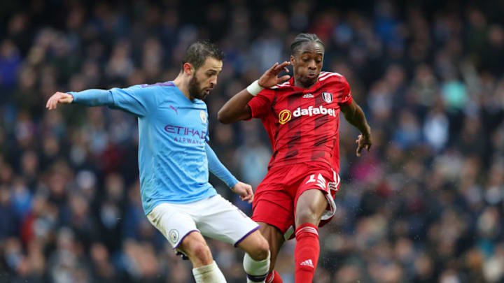 MANCHESTER, ENGLAND - JANUARY 26: Bernardo Silva of Manchester City is tackled by Terence Kongolo of Fulham during the FA Cup Fourth Round match between Manchester City and Fulham at Etihad Stadium on January 26, 2020 in Manchester, England. (Photo by Alex Livesey/Getty Images)