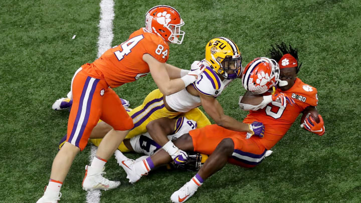 Travis Etienne #9 of the Clemson Tigers is tackled by Grant Delpit #7 of the LSU Tigers (Photo by Sean Gardner/Getty Images)