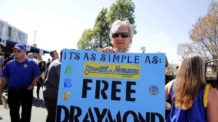 Jun 13, 2016; Oakland, CA, USA; Golden State Warriors fan Doug Anderson holds up a sign in support of Golden State Warriors suspended forward Draymond Green (not pictured) before game five of the NBA Finals against the Cleveland Cavaliers at Oracle Arena. Mandatory Credit: Kelley L Cox-USA TODAY Sports