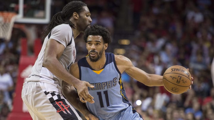 Jan 13, 2017; Houston, TX, USA; Memphis Grizzlies guard Mike Conley (11) drives to the basket past Houston Rockets center Nene Hilario (42) during the second half at the Toyota Center. The Grizzlies defeat the Rockets 110-105. Mandatory Credit: Jerome Miron-USA TODAY Sports