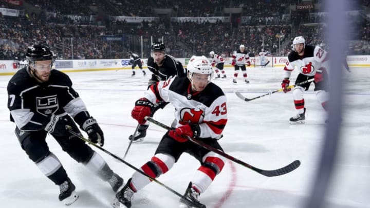 LOS ANGELES, CA - DECEMBER 6: Oscar Fantenberg #7 and Brett Seney #43 of the New Jersey Devils battle for the puck during the second period of the game at STAPLES Center on December 6, 2018 in Los Angeles, California. (Photo by Adam Pantozzi/NHLI via Getty Images)