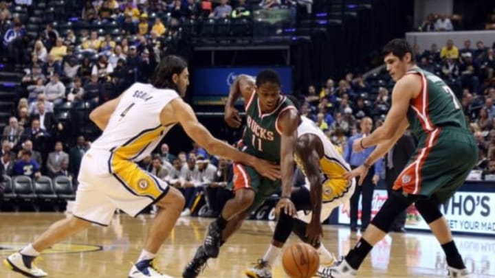 Nov 4, 2014; Indianapolis, IN, USA; Milwaukee Bucks guard Brandon Knight (11) drives to the basket against Indiana Pacers forward Luis Scola (4) at Bankers Life Fieldhouse. Mandatory Credit: Brian Spurlock-USA TODAY Sports