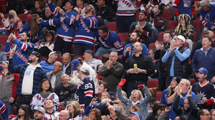GLENDALE, ARIZONA - DECEMBER 15: Fans of the New York Rangers cheer after a goal against the Arizona Coyotes during the third period of the NHL game at Gila River Arena on December 15, 2021 in Glendale, Arizona. The Rangers defeated the Coyotes 3-2. (Photo by Christian Petersen/Getty Images)
