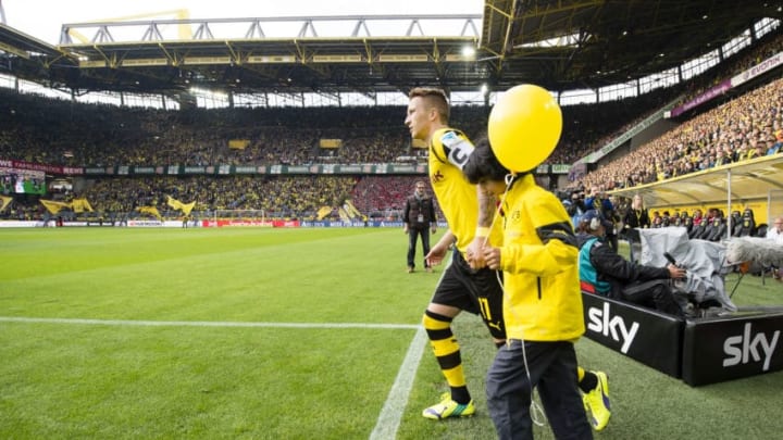DORTMUND, GERMANY - AUGUST 23: Marco Reus (BVB) enters the pitch as team captain of Borussia Dortmund for the first time at the Bundesliga match between Borussia Dortmund and Bayer 04 Leverkusen at Signal Iduna Park on August 23, 2014 in Dortmund, Germany. (Photo by Alexandre Simoes/Borussia Dortmund/Getty Images)