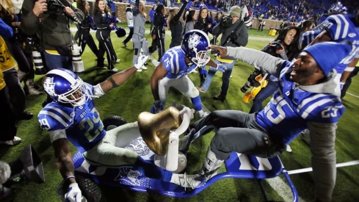 Nov 10, 2016; Durham, NC, USA; Duke Blue Devils running back Shaun Wilson (29) and running back Quay Mann (15) and running back Jela Duncan (25) celebrate with the victory bell after beating the North Carolina Tar Heels 28-27 at Wallace Wade Stadium. Mandatory Credit: Mark Dolejs-USA TODAY Sports