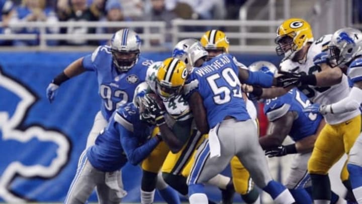 Dec 3, 2015; Detroit, MI, USA; Green Bay Packers running back James Starks (44) gets tackled by Detroit Lions strong safety Isa Abdul-Quddus (42) and middle linebacker Tahir Whitehead (59) during the first quarter at Ford Field. Mandatory Credit: Raj Mehta-USA TODAY Sports