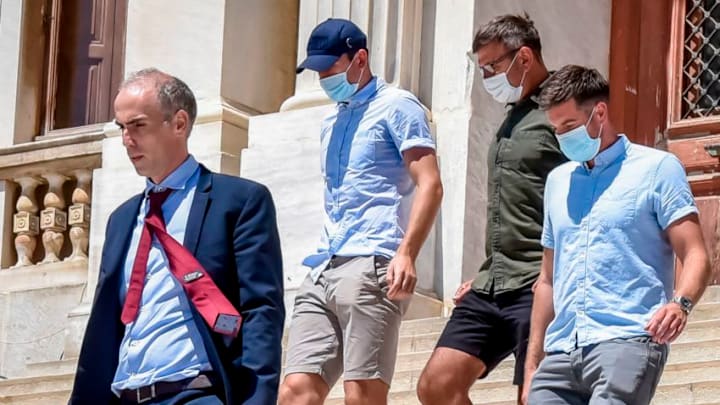 Manchester United football team captain Harry Maguire (2nd L) leaves a courthouse on the Greek island of Syros, the administrative hub of the Cycladic island group that includes Mykonos on August 22, 2020. - Maguire was released from Greek police custody on August 22, 2020, TV footage showed, pending a hearing on assault charges on the neighbouring island of Mykonos. The £80 million (88 million euros) defender was arrested late on August 20, after what Greek police described as an "altercation" between two groups of British tourists on Mykonos. (Photo by EUROKINISSI / AFP) (Photo by EUROKINISSI/AFP via Getty Images)