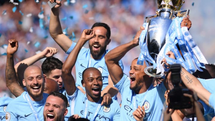 MANCHESTER, ENGLAND - MAY 06: Vincent Kompany of Manchester City lifts the Premier League Trophy alongside David Silva, Nicolas Otamendi and Fernandinho as Manchester City celebrate winning the Premier League Title during the Premier League match between Manchester City and Huddersfield Town at Etihad Stadium on May 6, 2018 in Manchester, England. (Photo by Laurence Griffiths/Getty Images)