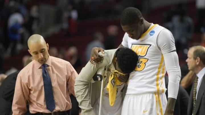 Mar 19, 2015; Portland, OR, USA; Virginia Commonwealth Rams guard Briante Weber (center) is consoled by forward Jarred Guest (23) and head coach Shaka Smart (left) against the Ohio State Buckeyes during overtime in the second round of the 2015 NCAA Tournament at Moda Center. The Buckeyes defeat the Rams 75-72. Mandatory Credit: Kirby Lee-USA TODAY Sports