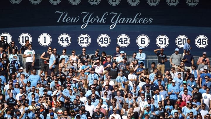 Aug 29, 2015; New York, NY, USA; New York City FC fans cheer in front of the retired numbers of the New York Yankees during the first half against the Columbus Crew SC at Yankee Stadium. Mandatory Credit: Danny Wild-USA TODAY Sports