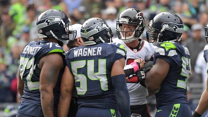 Oct 16, 2016; Seattle, WA, USA; Atlanta Falcons quarterback Matt Ryan (2) argues with Seattle Seahawks players Michael Bennett (72) and Bobby Wagner (54) and Cliff Avril (56) during a NFL football game at CenturyLink Field. Mandatory Credit: Kirby Lee-USA TODAY Sports