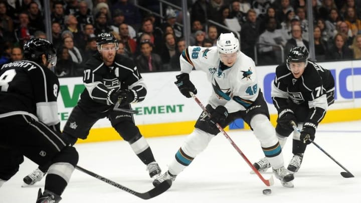 December 22, 2015; Los Angeles, CA, USA; San Jose Sharks center Tomas Hertl (48) moves the puck against the defense of Los Angeles Kings center Jeff Carter (77), left wing Tanner Pearson (70) and defenseman Drew Doughty (8) during the first period at Staples Center. Mandatory Credit: Gary A. Vasquez-USA TODAY Sports