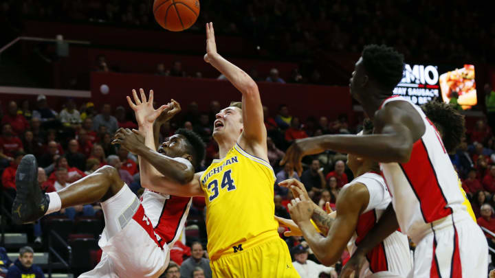 Feb 22, 2017; Piscataway, NJ, USA; Rutgers Scarlet Knights forward Jonathan Laurent (4) and Michigan Wolverines forward Mark Donnal (34) battle for a rebound during the first half at Louis Brown Athletic Center. Mandatory Credit: Noah K. Murray-USA TODAY Sports