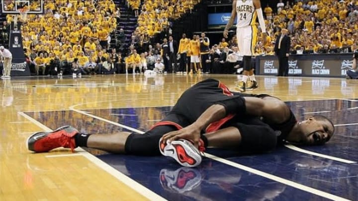 May 28, 2013; Indianapolis, IN, USA; Miami Heat center Chris Bosh (1) falls down on the the floor in pain while playing against the Indiana Pacers in game four of the Eastern Conference finals of the 2013 NBA Playoffs at Bankers Life Fieldhouse. Indiana defeats Miami 99-92. Mandatory Credit: Brian Spurlock-USA TODAY Sports