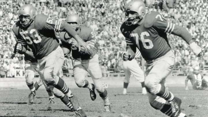 The San Francisco 49ers block for Hugh McElhenny #39 (Photo by Robert Riger/Getty Images)