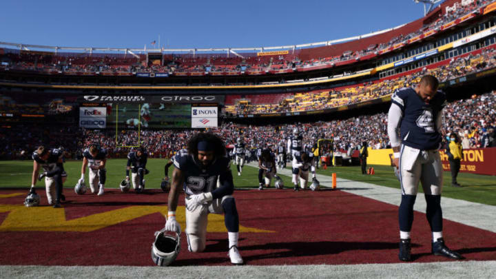 LANDOVER, MARYLAND - DECEMBER 12: Ezekiel Elliott #21 and Dak Prescott #4 of the Dallas Cowboys take a moment prior to the game against the Washington Football Team at FedExField on December 12, 2021 in Landover, Maryland. (Photo by Rob Carr/Getty Images)