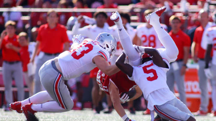 PISCATAWAY, NEW JERSEY - OCTOBER 02: Garrett Wilson #5 of the Ohio State Buckeyes tackles Tre Avery #21 of the Rutgers Scarlet Knights at SHI Stadium on October 02, 2021 in Piscataway, New Jersey. (Photo by Mike Stobe/Getty Images)