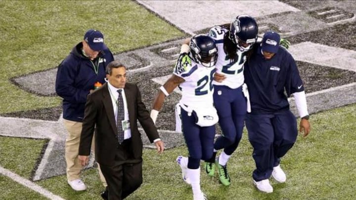 Feb 2, 2014; East Rutherford, NJ, USA; Seattle Seahawks cornerback Richard Sherman (25) is helped off the field after an injury in the second half against the Denver Broncos in Super Bowl XLVIII at MetLife Stadium. Mandatory Credit: Anthony Gruppuso-USA TODAY Sports