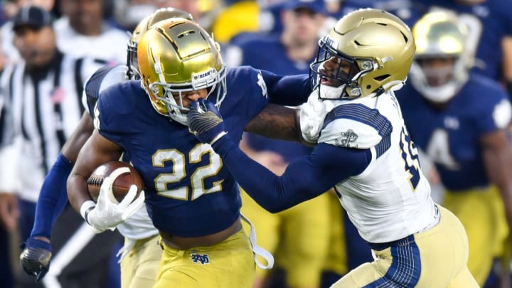 Nov 6, 2021; South Bend, Indiana, USA; Notre Dame Fighting Irish running back Logan Diggs (22) runs the ball against Navy Midshipmen safety Rayuan Lane (18) in the fourth quarter at Notre Dame Stadium. Mandatory Credit: Matt Cashore-USA TODAY Sports