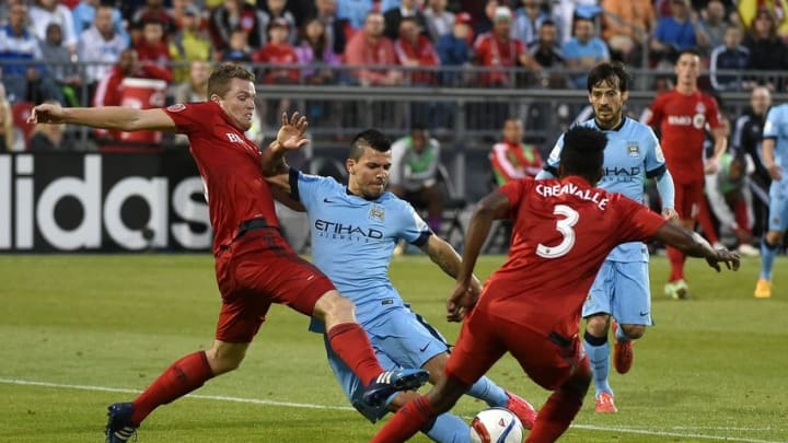 May 27, 2015; Toronto, Ontario, Canada; Manchester City forward Sergio Aguero (16) has his shot blocked by Toronto FC defenders Nick Hagglund (6) and Warren Creavalle (3) during the second half of an international club friendly at BMO Field. Mandatory Credit: Dan Hamilton-USA TODAY Sports