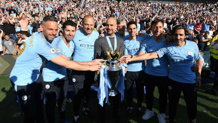 BRIGHTON, ENGLAND - MAY 12: Josep Guardiola, Manager of Manchester City and staff celebrate with the Premier League Trophy after winning the title following the Premier League match between Brighton & Hove Albion and Manchester City at American Express Community Stadium on May 12, 2019 in Brighton, United Kingdom. (Photo by Michael Regan/Getty Images)